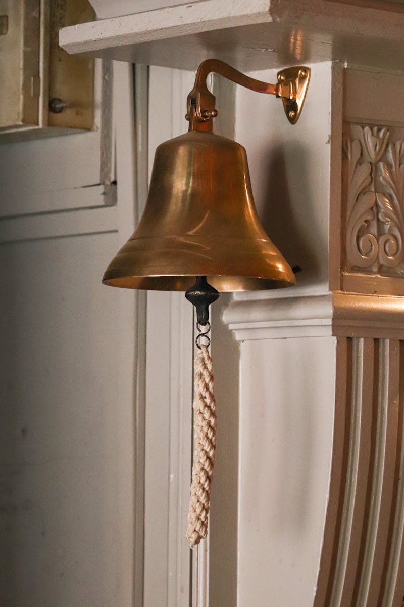 Brass Hanging Bell on a Wall